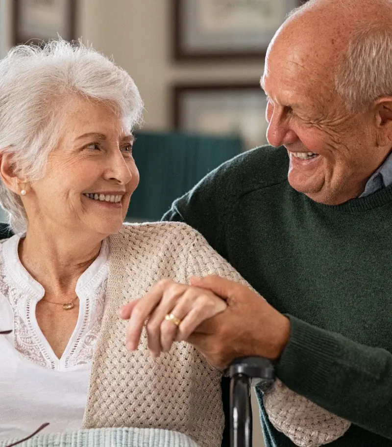 Photo of an elderly couple looking at one another and smiling