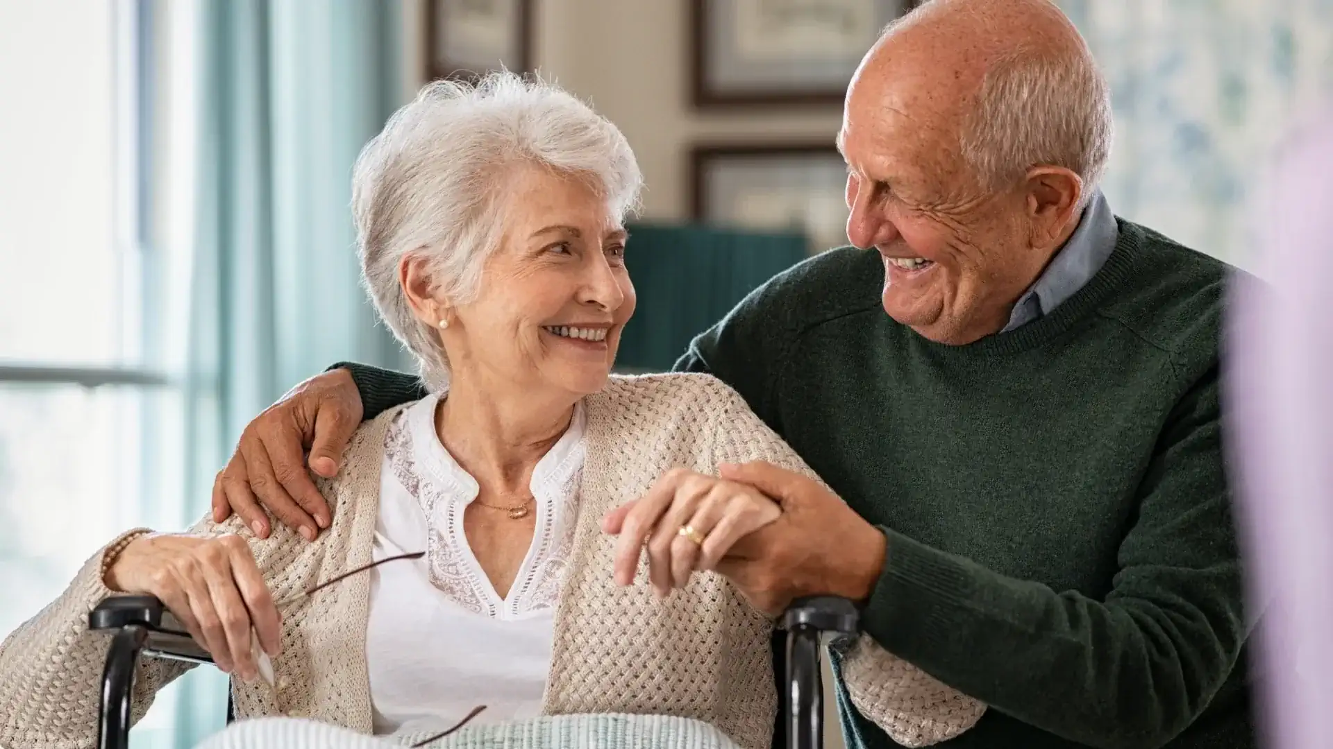 Photo of an elderly couple looking at one another and smiling