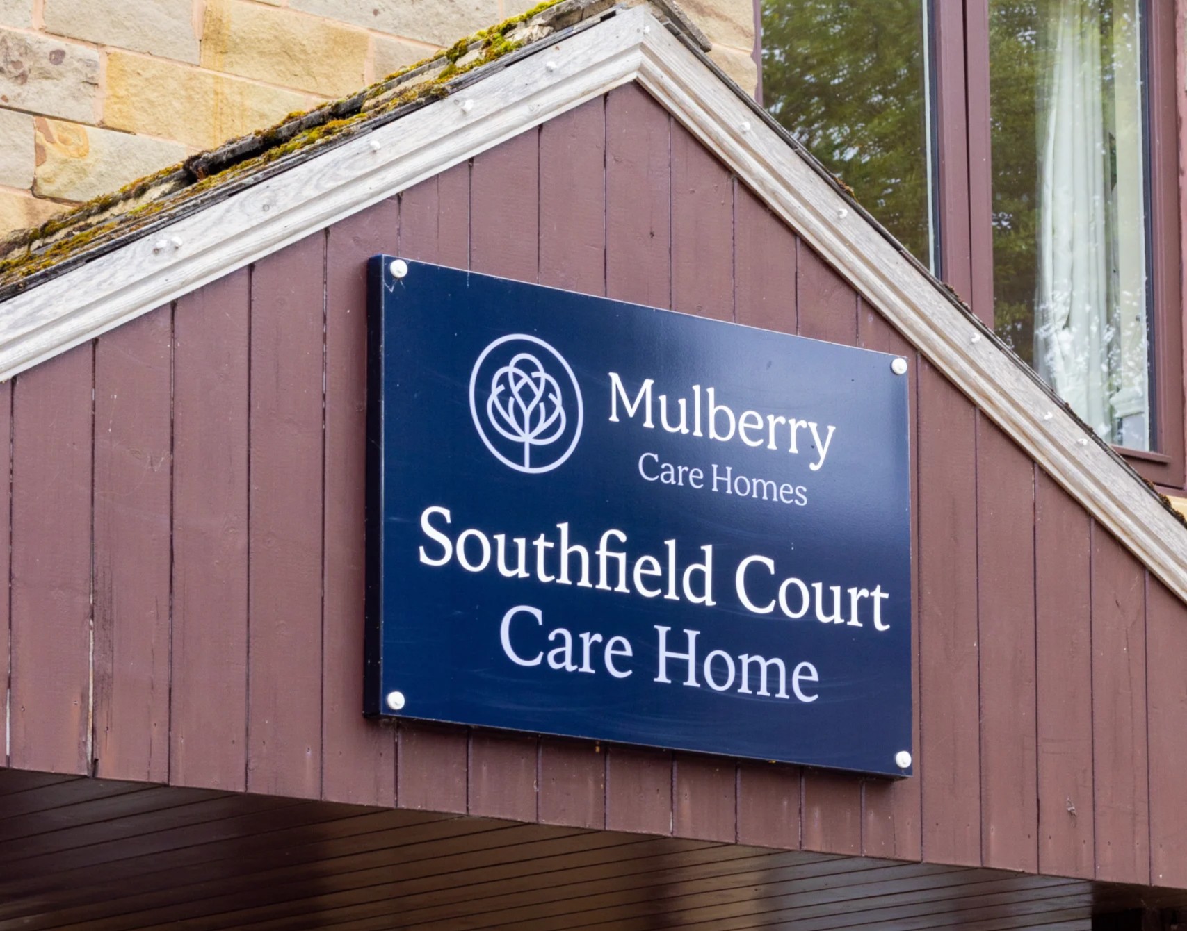 A sign of Southfield Court hanging above the entrance to the care home.